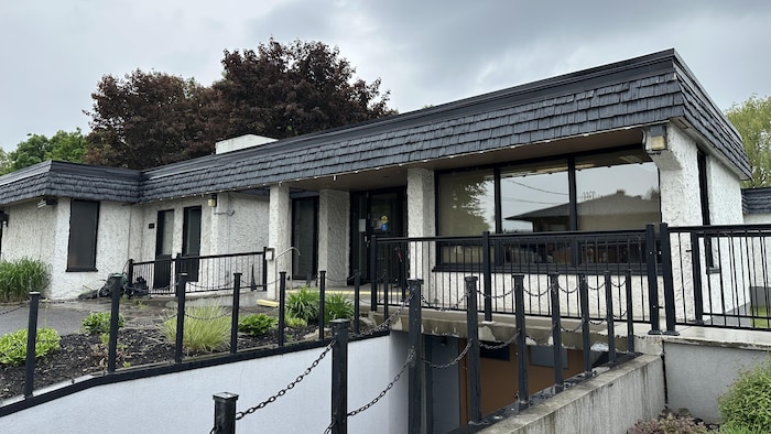 Un bâtiment blanc et noir avec des fenêtres.