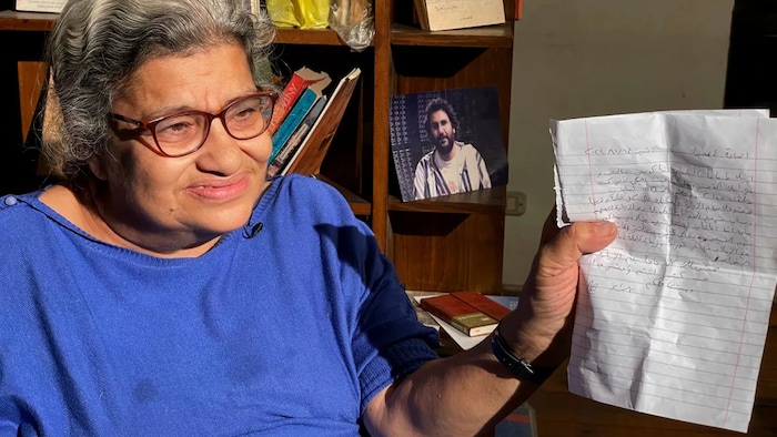 Laila Soueif holds the letter she got from Abdel-Fattah Tuesday. In it, he said he had started to drink and eat again and would explain why. (Amr Nabil/The Associated Press)