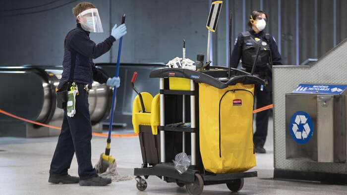 Un employé d'entretien nettoie le plancher à la station Berri-UQAM.