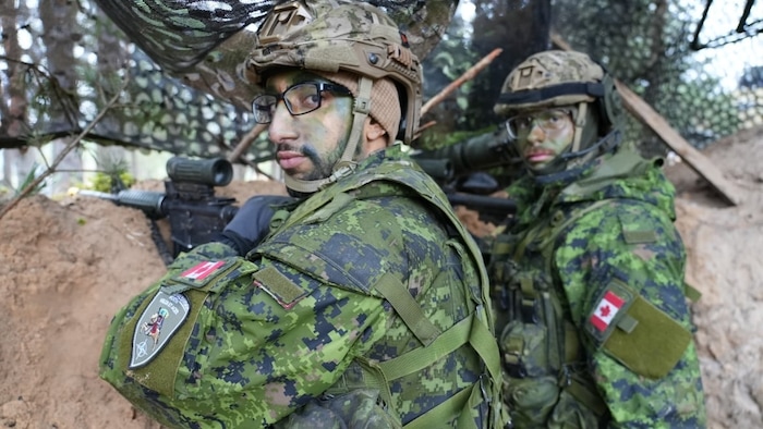 Cpl. Youssef Zitouni and Cpl. Oliver Hutpays demonstrate how they would observe enemy movements from a trench during the exercises.