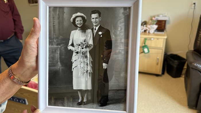 Une photo de mariage en noir et blanc dans un cadre. 
