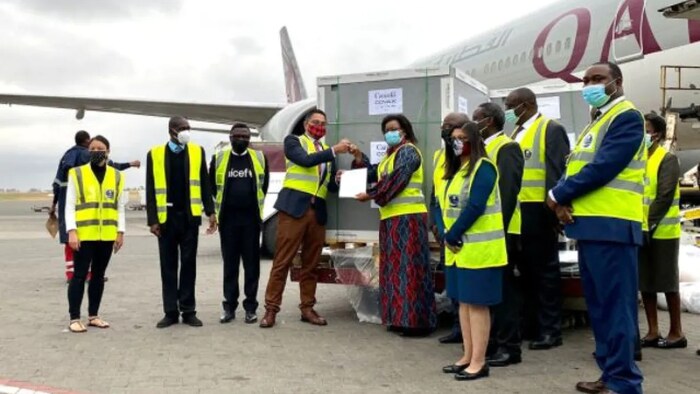Officials posed next to Canada's first donated doses of the AstraZeneca vaccine, which arrived in three countries in Africa on Sept. 2, 2021. The doses were part of a Canadian pledge to COVAX. 