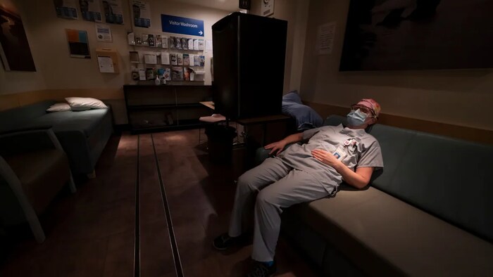 Intensive care unit nurse Sophie Gabiniewicz rests in one of the staff rooms during her shift at St. Paul's Hospital in downtown Vancouver, Friday, December 4, 2020.