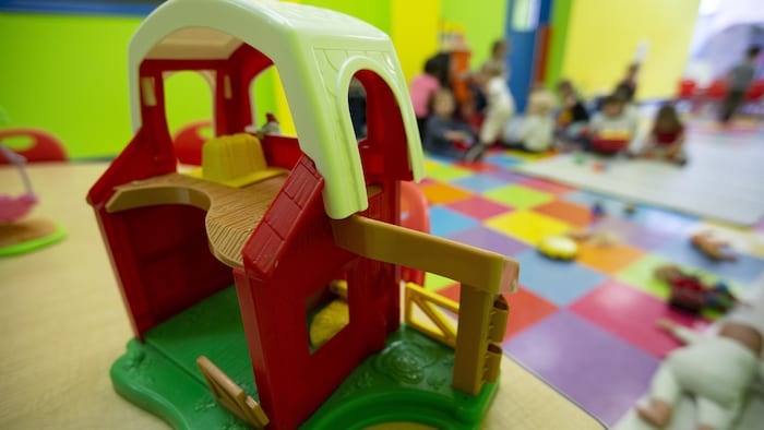 Des jouets et des enfants en arrière-plan.