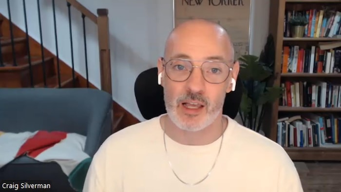 Un homme parle à la caméra.