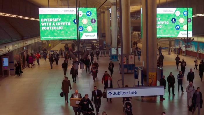 Giant electronic billboards display adverts for cryptocurrency investment companies in a London tube station in 2018. Since then the number of cryptocurrencies has exploded to more than 16,000. 