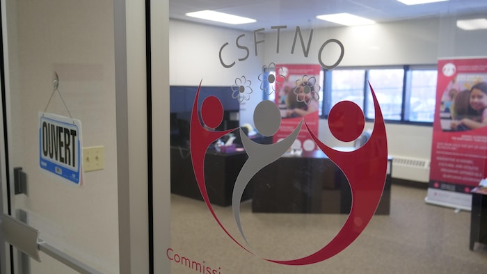 Un logo de la CSFTNO dans la porte qui donne sur ses bureaux. 