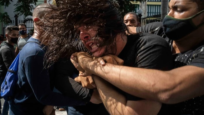 Plainclothes police detain an anti-government protester during a protest in Havana, Cuba, Sunday, July 11, 2021. Hundreds of demonstrators went out to the streets in several cities in Cuba to protest against ongoing food shortages and high prices of foodstuffs, amid the new coronavirus crisis.