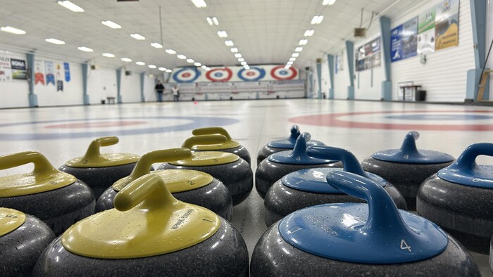 Des pierres de curling posées sur la glace.
