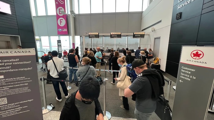 A photo taken Sunday at the customer service desk at Toronto's Pearson International Airport gives a glimpse of some of the long lineups air travellers have been facing lately. (Jacob Barker/CBC)