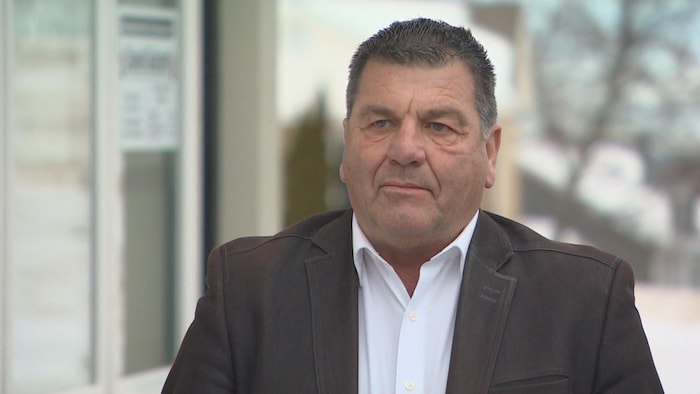 A man in an interview outside. mayors choose pay their pocket