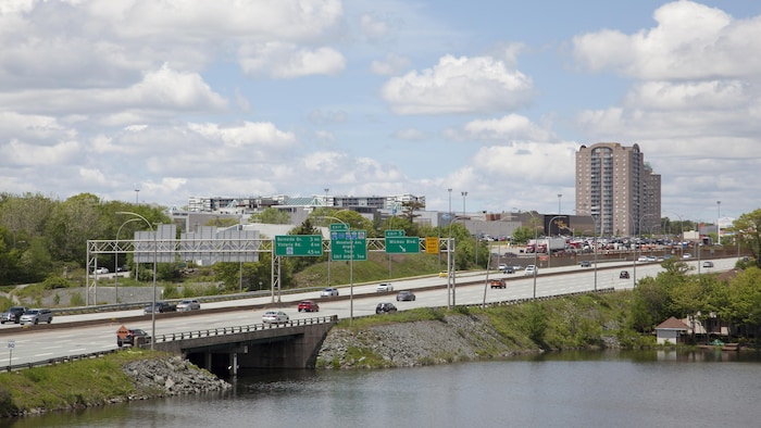 Une autoroute qui passe au-dessus du lac et mène à un centre commercial. 