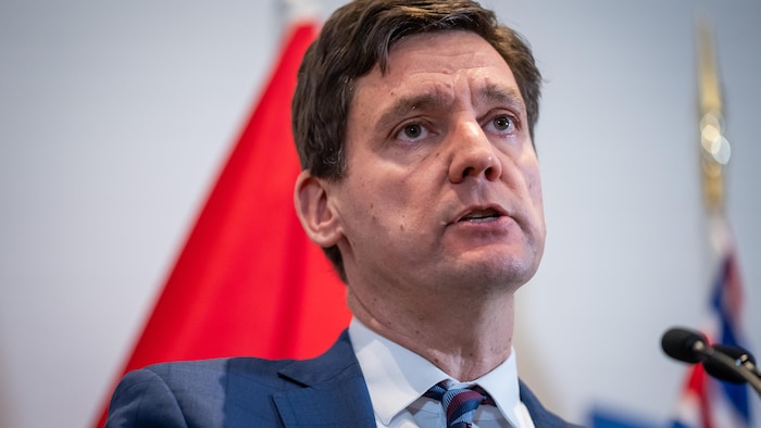 David Eby parle devant un microphone.