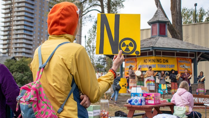 Un manifestant tient une pancarte contre les déchets nucléaires.