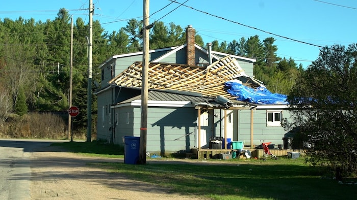 Une maison dont une partie du toit a été arrachée en raison de la tempête.