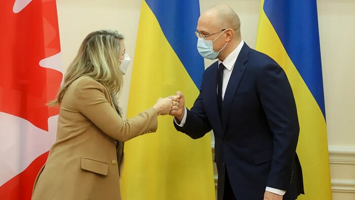 In this photo provided by the Ukrainian Prime Minister's Press Office, Ukraine's Prime Minister Denis Shmyhal, right, and Canada's Minister of Foreign Affairs Melanie Joly greet each other during their meeting in Kyiv, Ukraine on Monday, Jan. 17, 2022. 