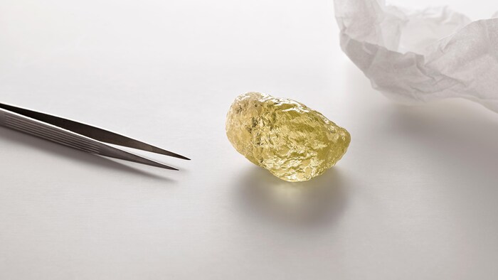 Un diamant jaune de forme inégale et à la surface plissée.
