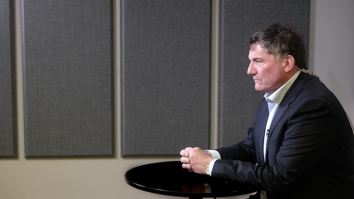 Dominic LeBlanc assis à une table pendant une entrevue.