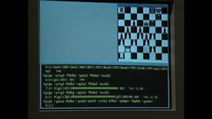 Écran d'ordinateur avec un jeu d'échecs et des lignes de codes.
