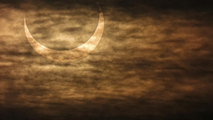 Un croissant de soleil dans les nuages.