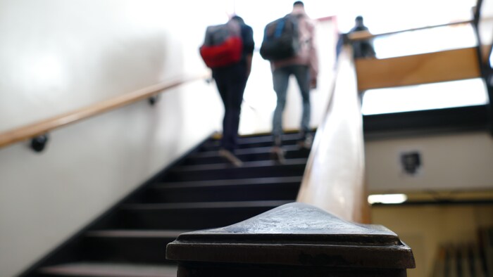 Des étudiants montent un escalier.