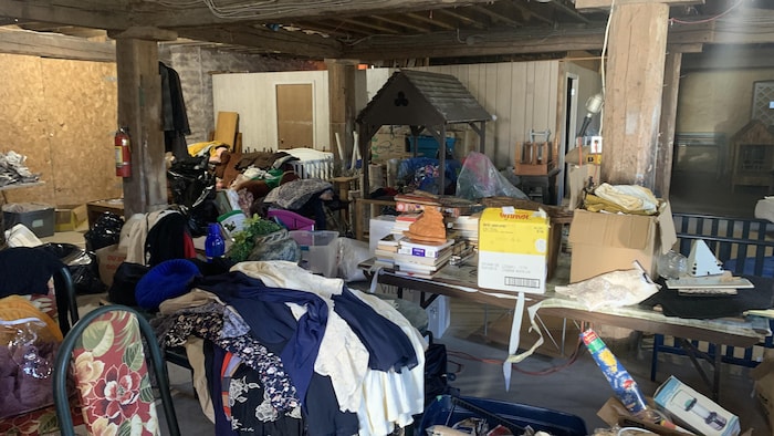 Des objets et vêtements entassés dans un sous-sol.
