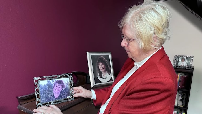 Ellen Judd tient un cadre avec une photo de Christine Egan.