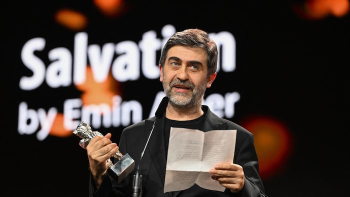 Le réalisateur turc Emin Alper lit un discours, lettre et Ours d'argent à la main.
