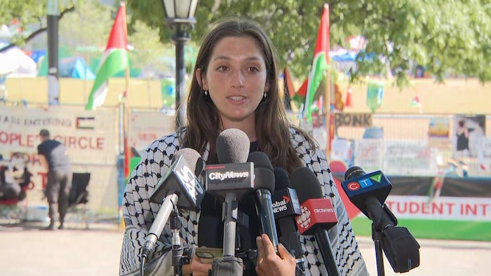 Fourth-year undergrad and encampment spokesperson Erin Mackey speaks to reporters in a pro-Palestinian encampment on the main campus of the University of Toronto on May 24, 2024.