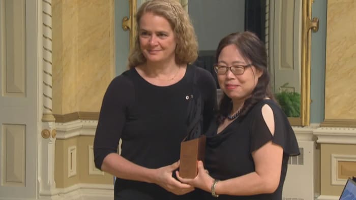 Qiu, right, was given a Governor General's award in 2018 for helping to develop ZMapp, a treatment for the deadly Ebola virus. 