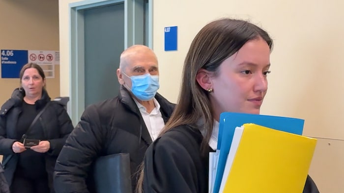 L'homme au crâne dégarnie porte un masque chirurgical.