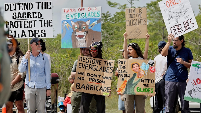 People with placards. trump visits &quot. alcatraz alligators&quot. , detention trump visits "alcatraz alligators", detention new trump visits "alcatraz alligators", detention new trump visits "alcatraz alligators", detention new