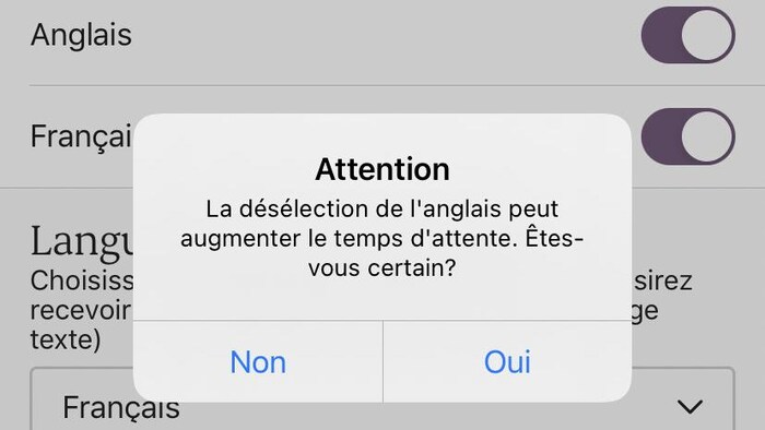 Une capture d'écran sur laquelle on peut lire le message suivant : «Attention – La désélection de l'anglais peut augmenter le temps d'attente. Êtes-vous certain?»