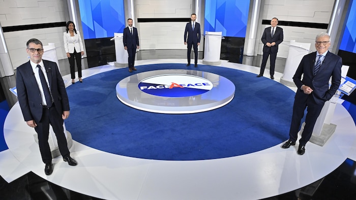 From left to right, Conservative Leader Eric Duhaime, Liberal Leader Dominique Anglade, Quebec Solidaire co-spokesperson Gabriel Nadeau-Dubois, Parti-Quebecois Leader Paul St-Pierre Plamondon, Legault and moderator Pierre Brunei, stand on the set prior to the leaders debate in Montreal, on Sept. 15.