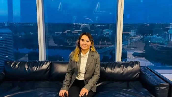 Farkhunda Hashimy pose pour la photo, assise sur un divan. 