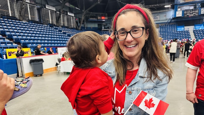 A woman holding a child in her arms. canada day: multiculturalism highlighted canada day: multiculturalism highlighted new