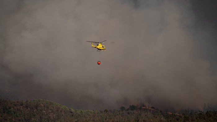 Des hélicoptères de lutte contre les incendies combattent un feu de forêt près de Valverde del Camino, dans la province de Huelva, au sud-ouest de l'Espagne, le 10 août 2026.