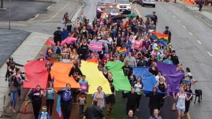 Un défilé avec des drapeaux multicolores. 