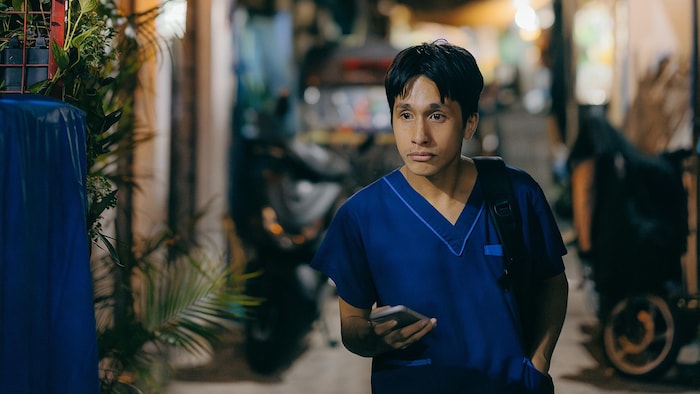 Nurse Vincent Castro, pictured near his home, promised his mother that he would leave for abroad. He didn't get to do that before she died of colon cancer. (Jilson Tiu)