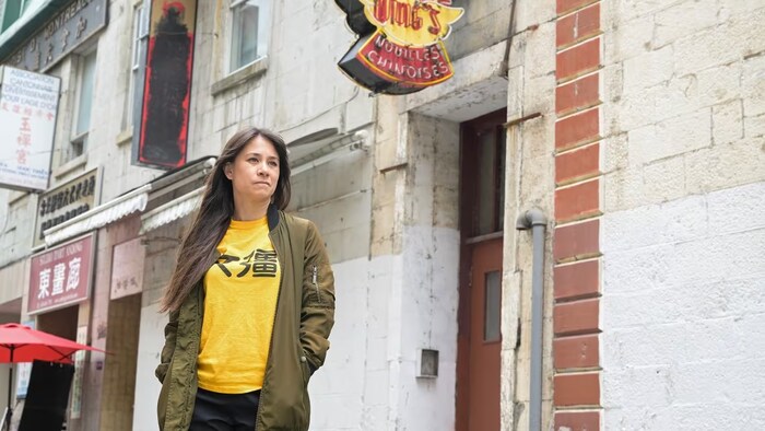 Karen Cho, director of Big Fight in Little Chinatown poses in front of Wing's Noodles in Montreal's Chinatown. (Graham Hughes/The Canadian Press)