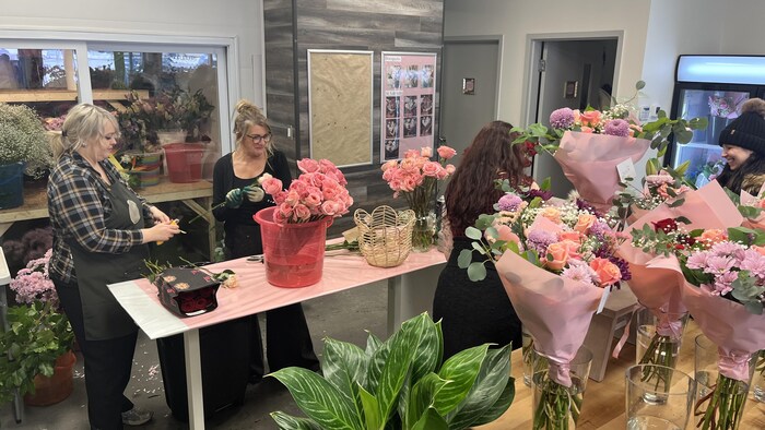 Plusieurs bouquets de fleurs dans une boutique.
