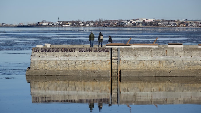 Des marcheurs au brise-lame de Rimouski, le 27 décembre 2023.