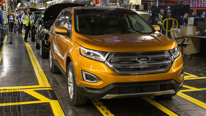 A Ford Edge comes off the assembly line in Oakville, Ont. But in the EV era, will U.S. automakers build plants here if most of their customers would have to pay thousand of dollars more for Canadian-made cars?