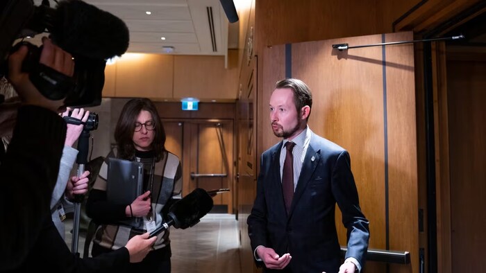 Conservative MP Michael Cooper speaks to members of the media during a break at the Standing Committee on Procedure and House Affairs (PROC) regarding foreign election interference on Parliament Hill in Ottawa, on Wednesday, March 1, 2023. (Spencer Colby/Canadian Press)
