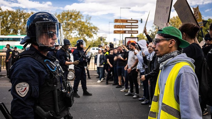 Une confrontation entre un militant, un manifestant des « gilets jaunes » et un policier de la brigade anti-émeute.