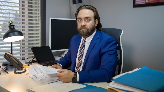 Une homme assis à son bureau.
