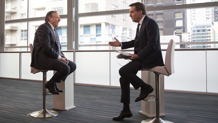 Deux hommes discutent face à face. 