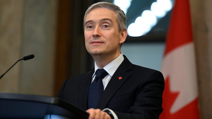 François-Philippe Champagne derrière un lutrin. 