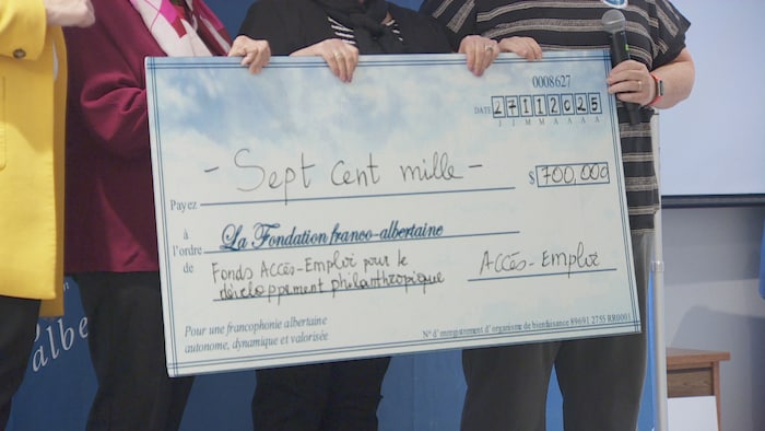 Des personnes tiennent un chèque géant représentant un don de 700 000 $ à La Fondation franco-albertaine du Fonds Accès-Emploi pour le développement philanthropique.