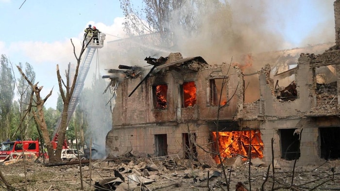 Rescuers hosed down the burning building, which was largely destroyed.